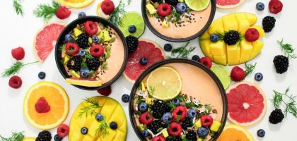 A colorful assortment of fresh fruit bowls featuring mixed berries and citrus slices, perfect for healthy eating inspiration.