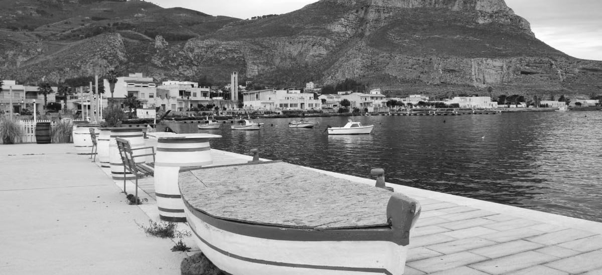 Monochrome view of a serene coastal town in Sicilia, Italy.